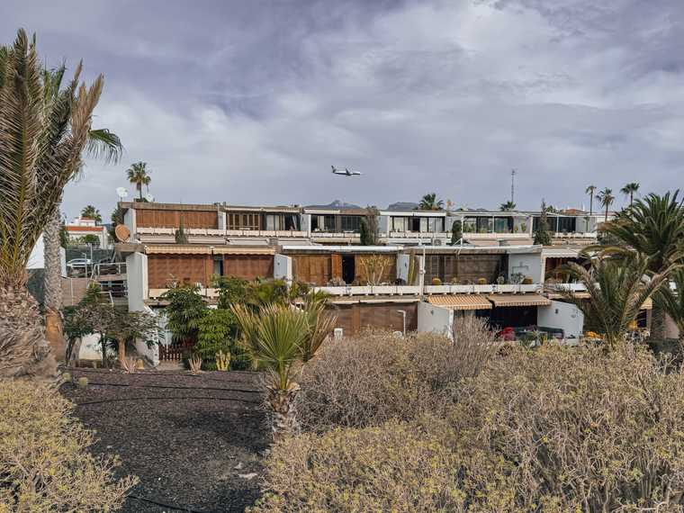 A plane flies over a block of apartments in Tenerife, Spain.